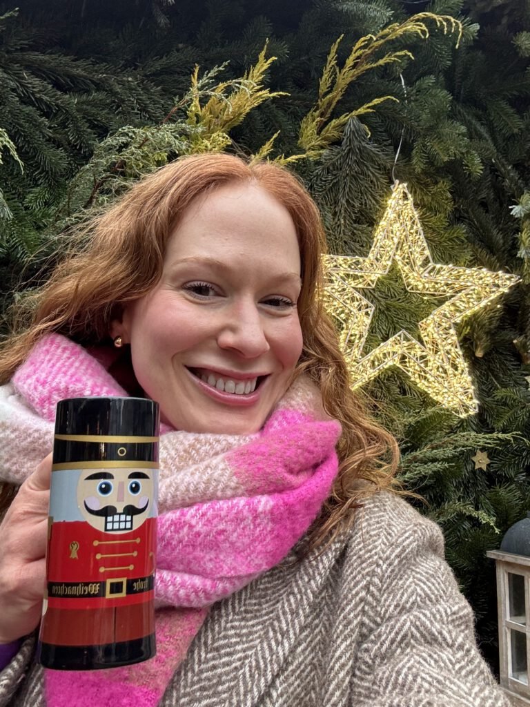 Woman holding nutcracker mug at christmas market