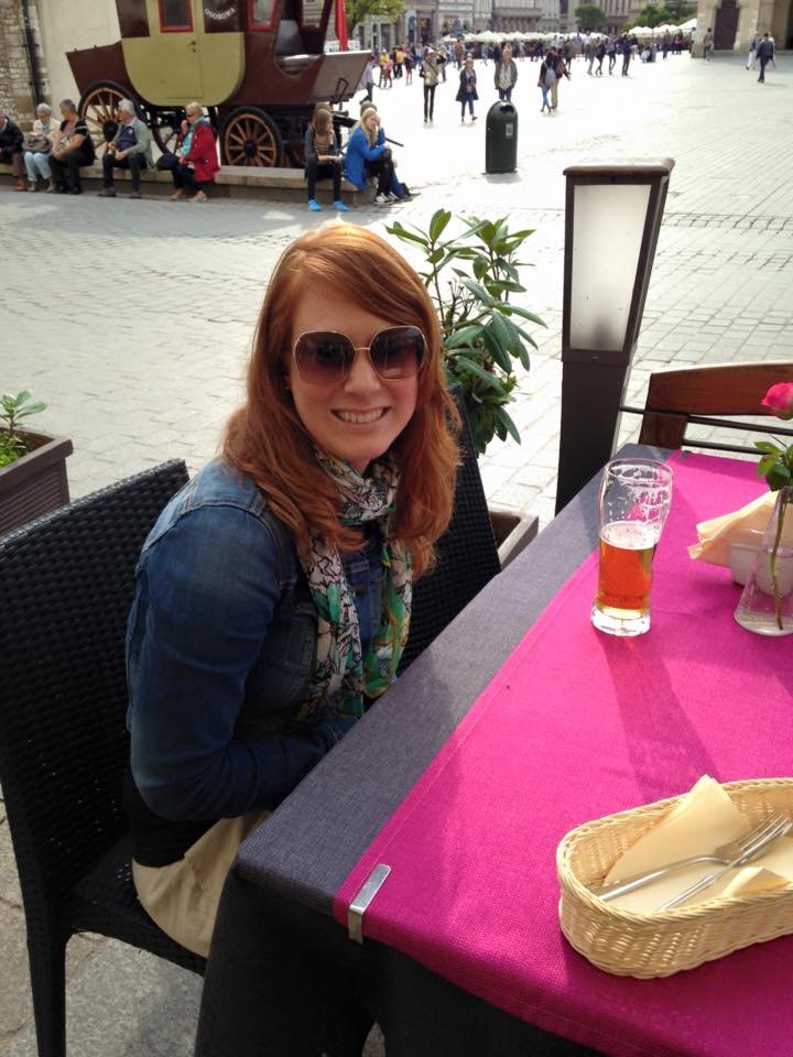 Woman sitting in square in Krakow, Poland